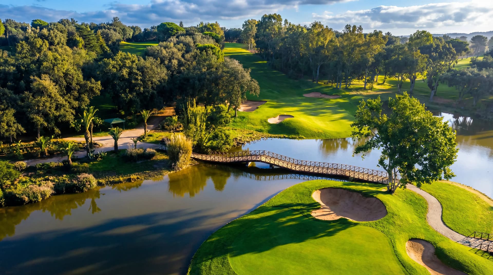 Panoramic view of Atlas Mountains Morocco golf course with green fairways at sunset - Premium Golf Tours Morocco