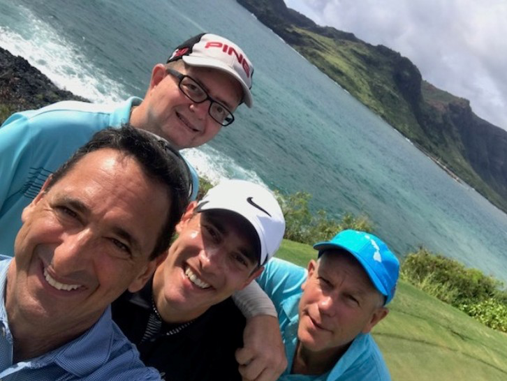 Happy golfers enjoying a scenic coastal golf course